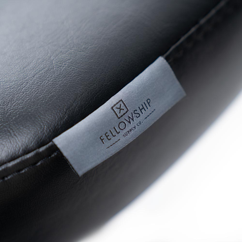 Brand tag detail on Adjustable Tattoo Artist Chair 9942 on white background